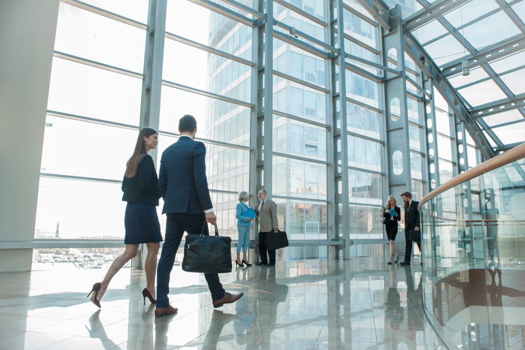 Businesspeople walking in modern glass office building