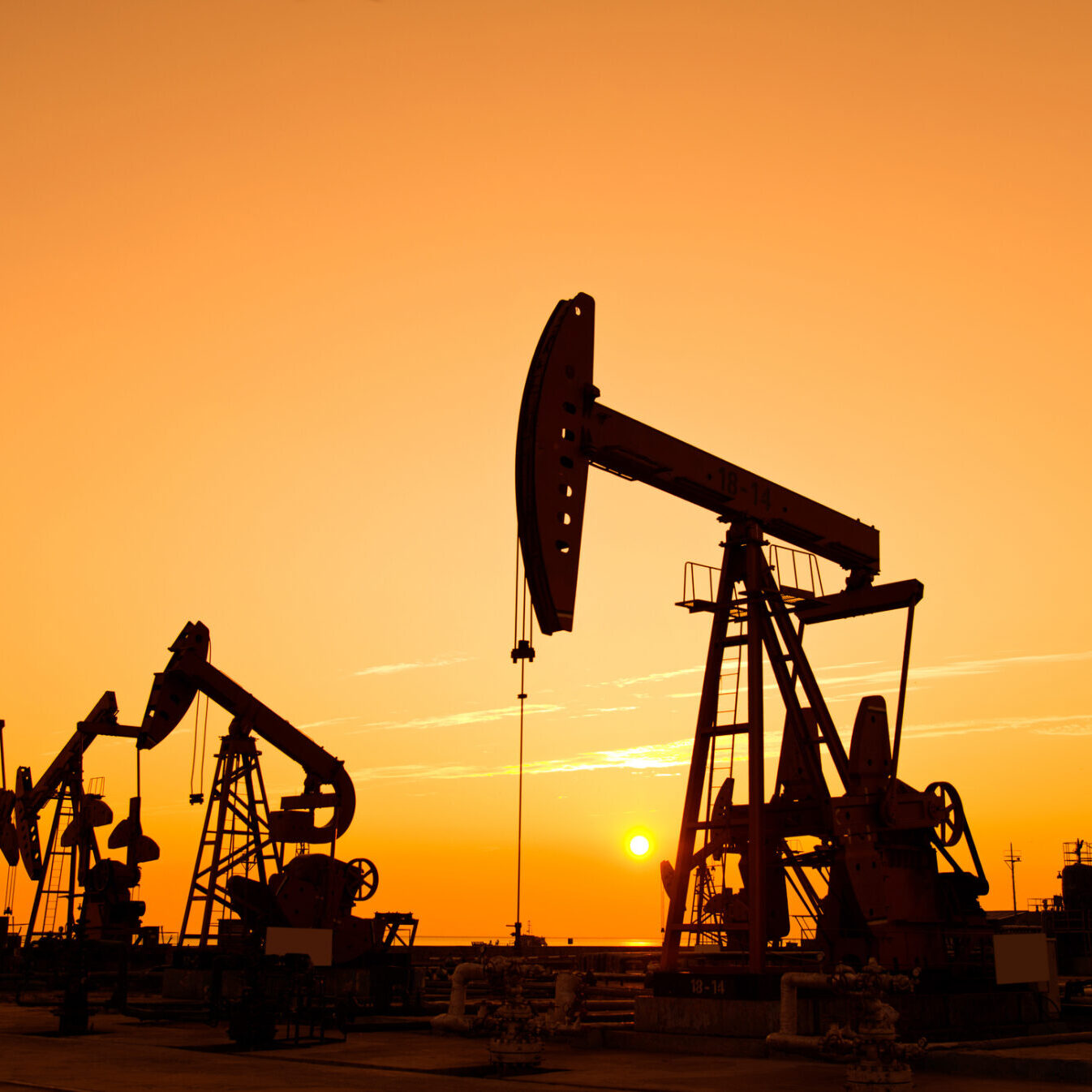 Oil pumps and rig at sunset