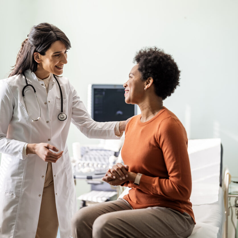 Female medical practitioner reassuring a patient