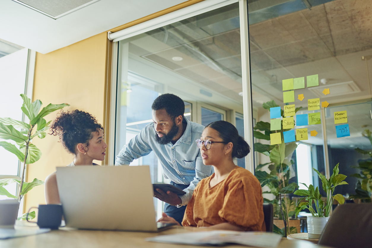 Three diverse professionals in business attire in an office