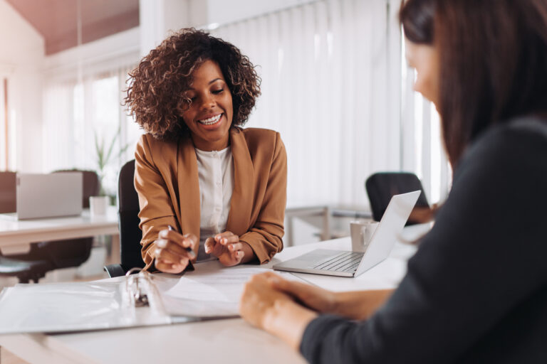 Female client consulting with an agent in the office